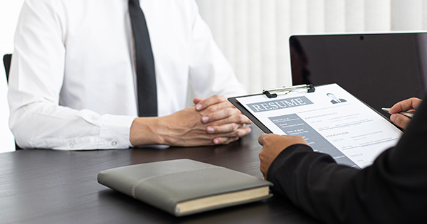 services-labor-and-employment-advisorysservices HR head is reading the resume and information about the candidate's history