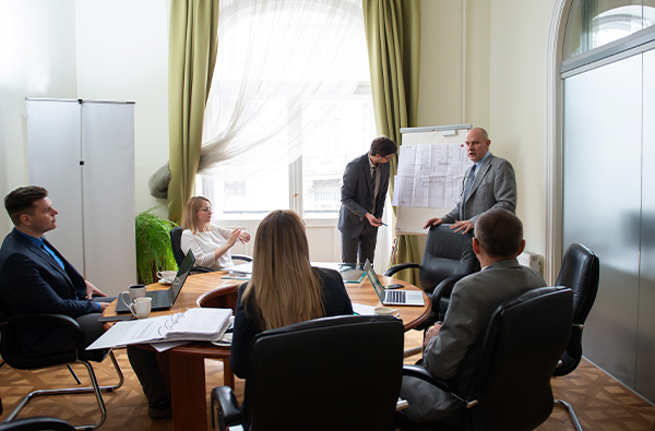 services-training-and-capacity-building Diverse business team discussing project at corporate briefing in boardroom